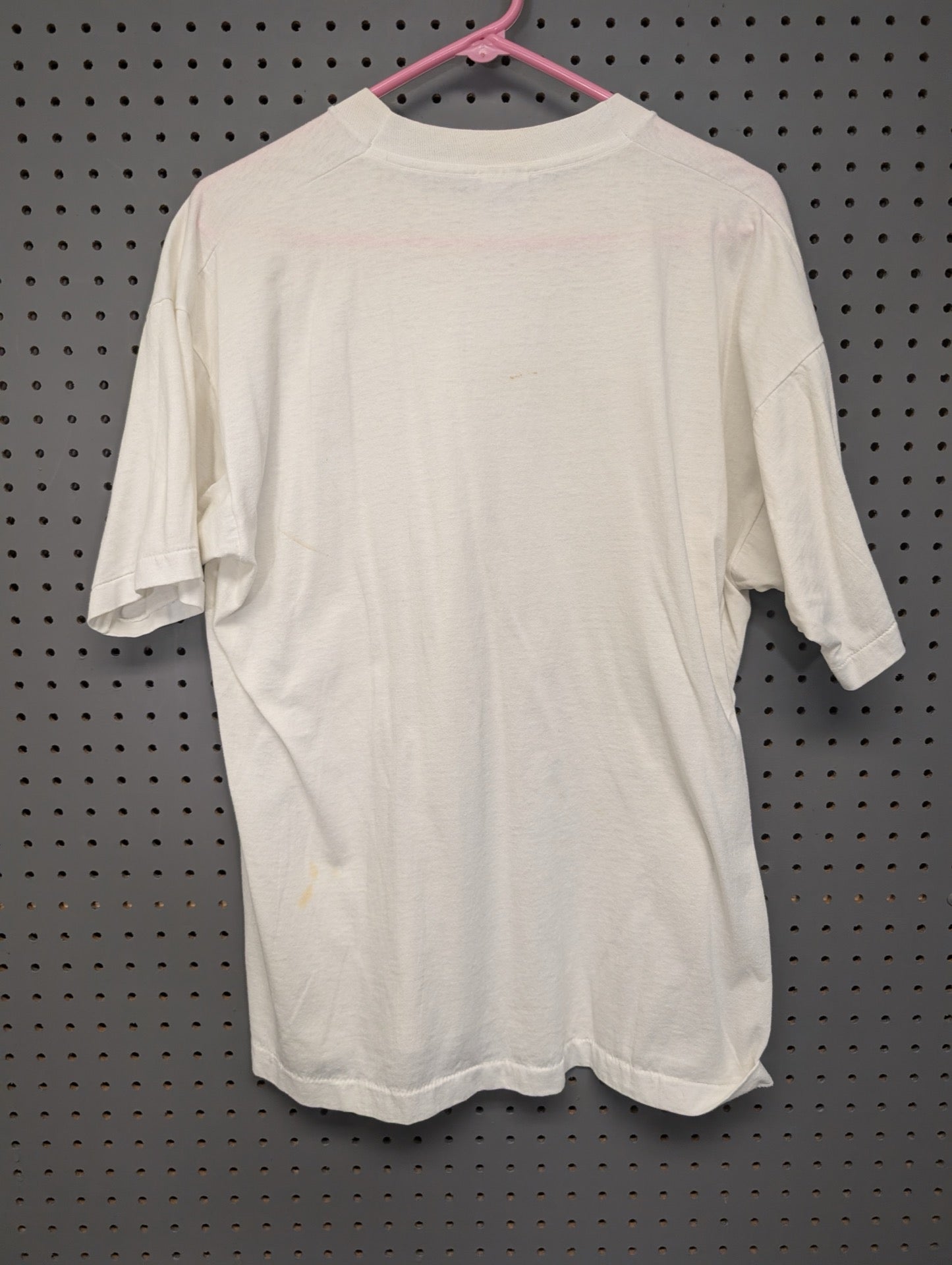 Back view of white vintage t-shirt showing faint stains