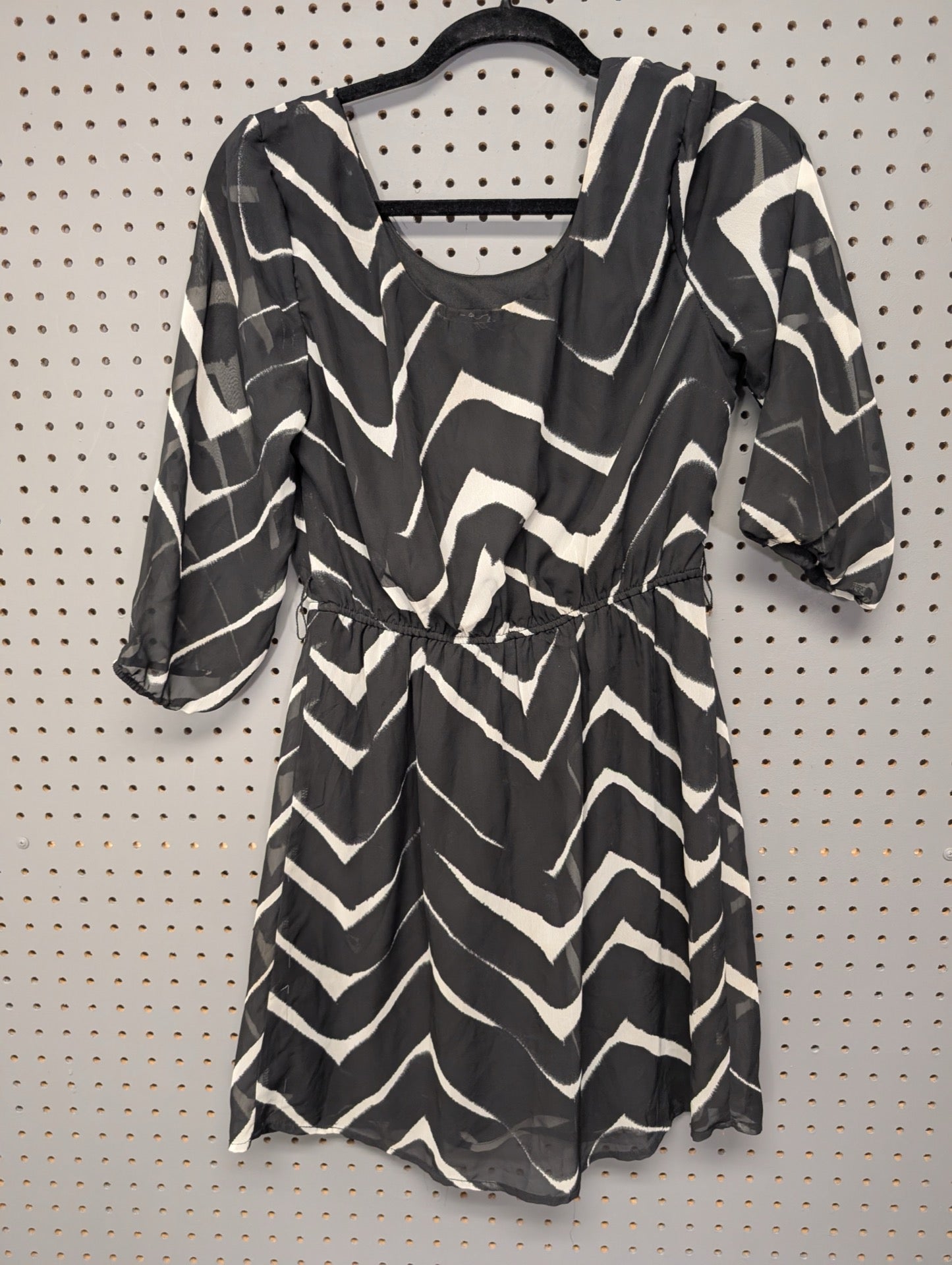 Back view of black and white sheer chevron dress