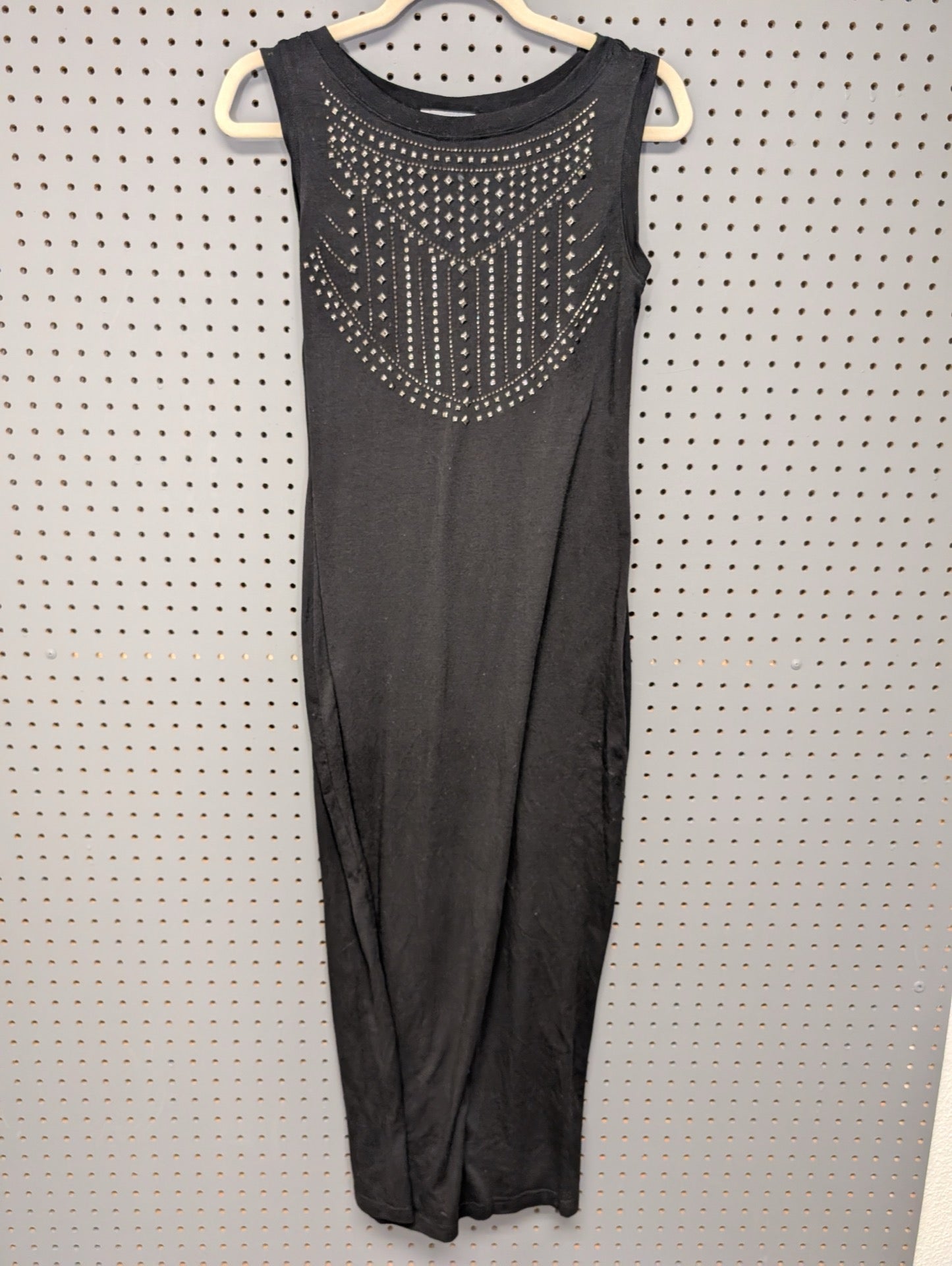 Front view of black sleeveless dress with silver studs