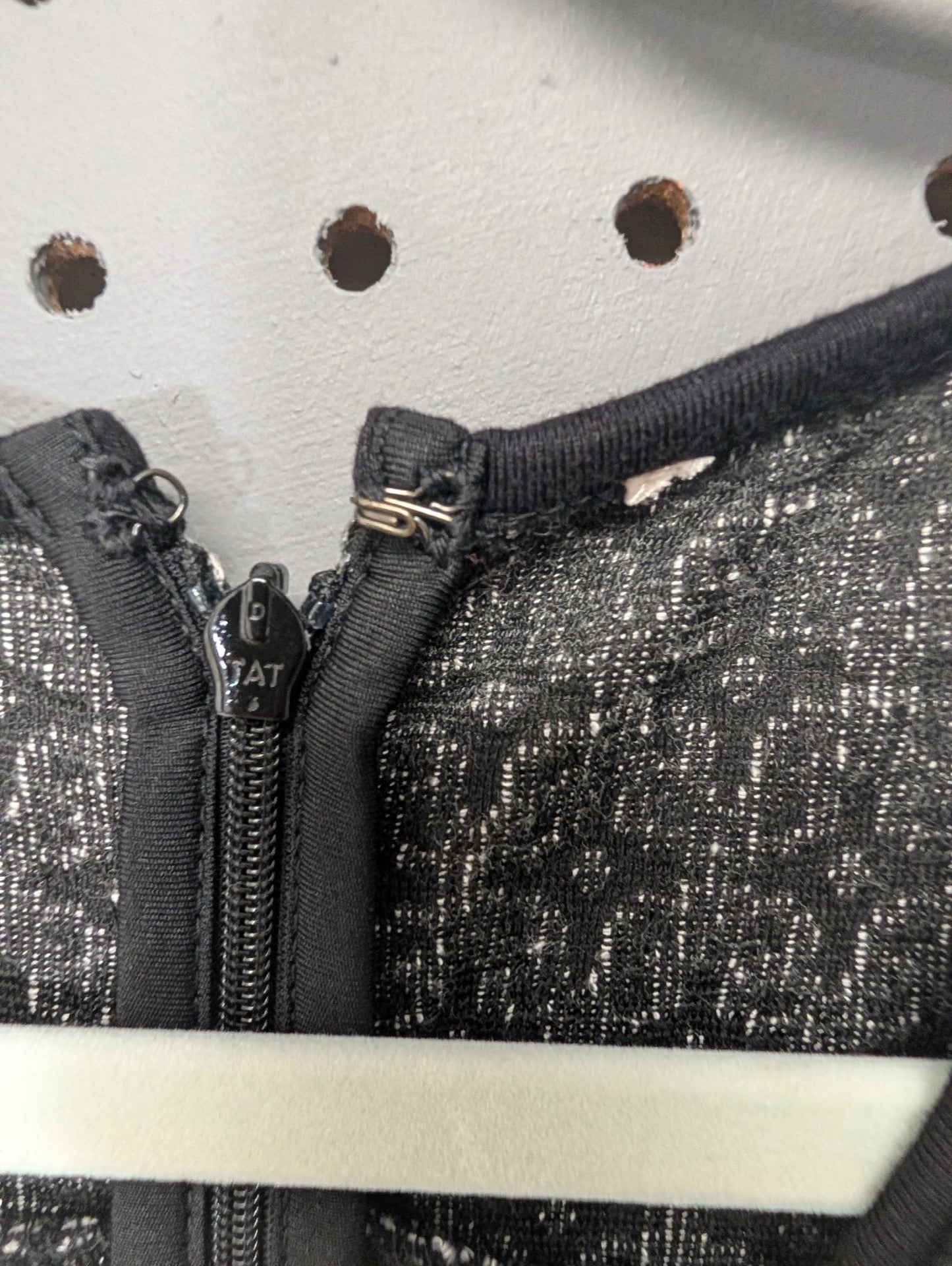 Close up of the back zipper on the geometric dress