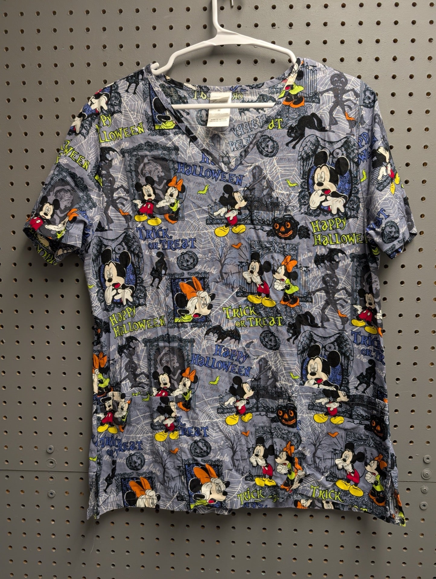 Front view of blue Halloween Mickey Mouse scrub top