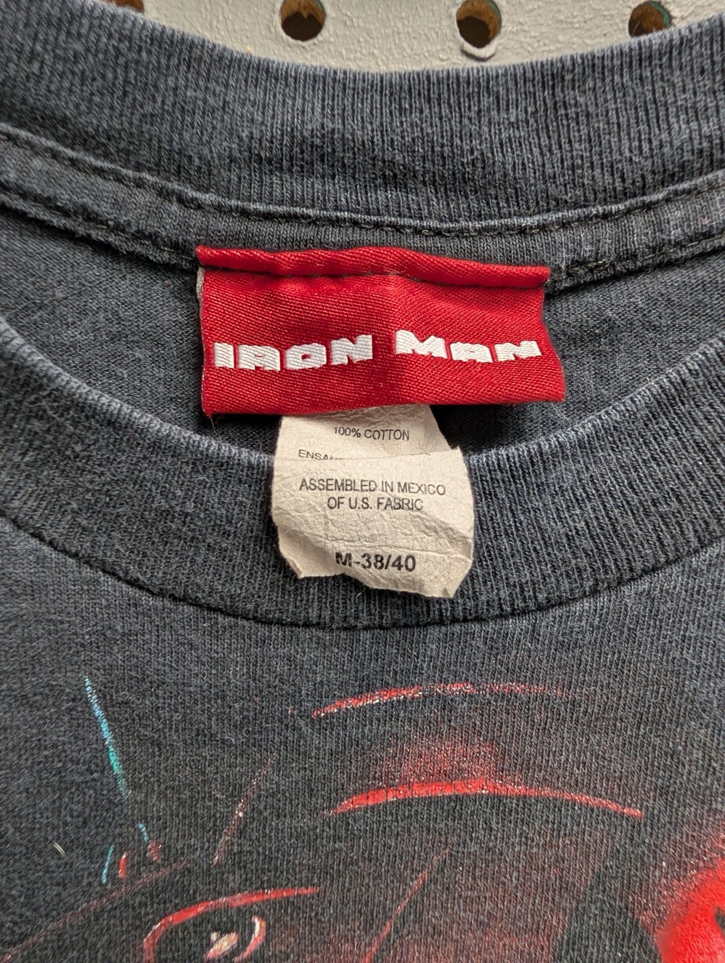 Close up of red Iron Man size Medium tag
