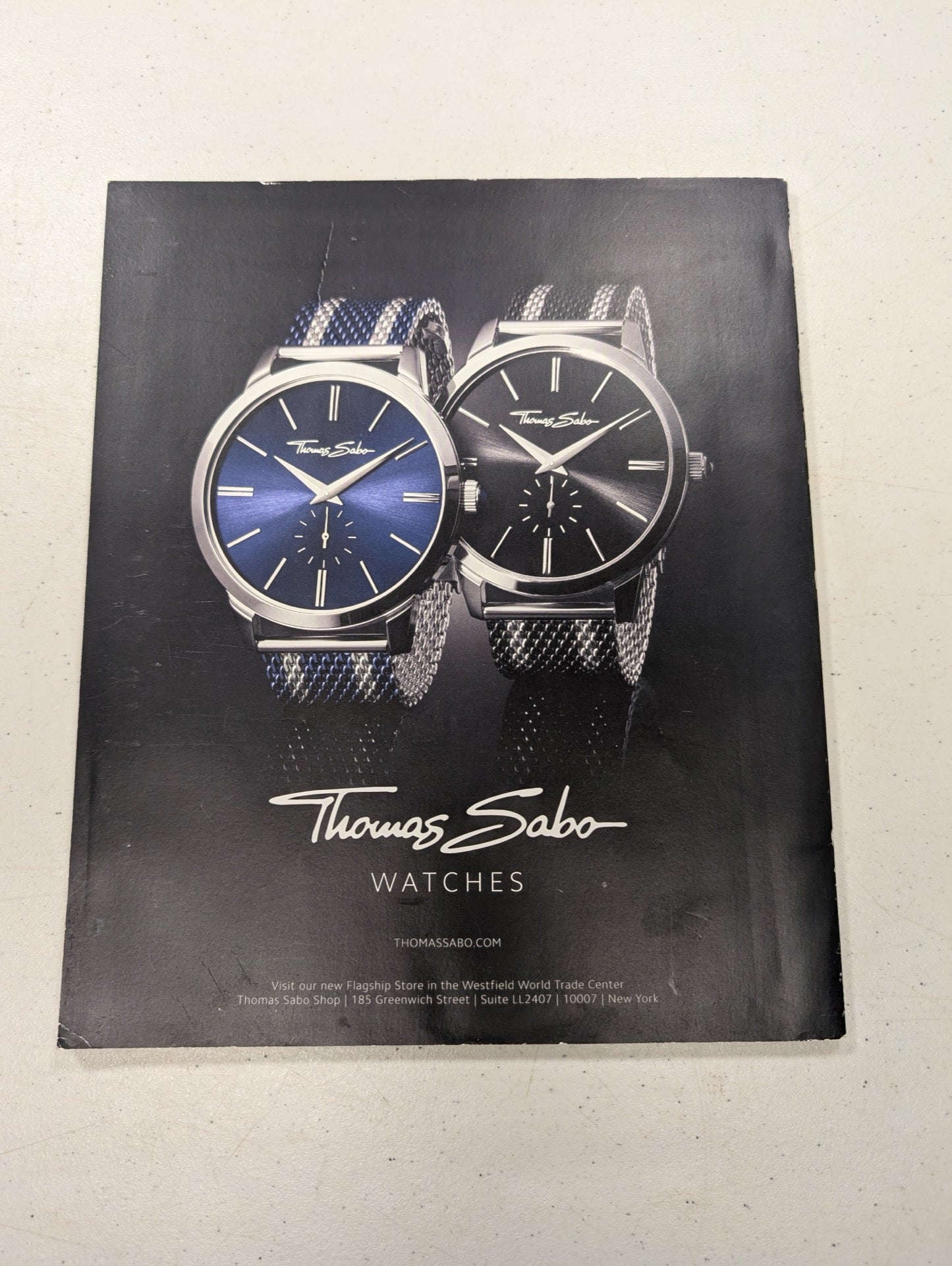 Back cover featuring watch advertisement