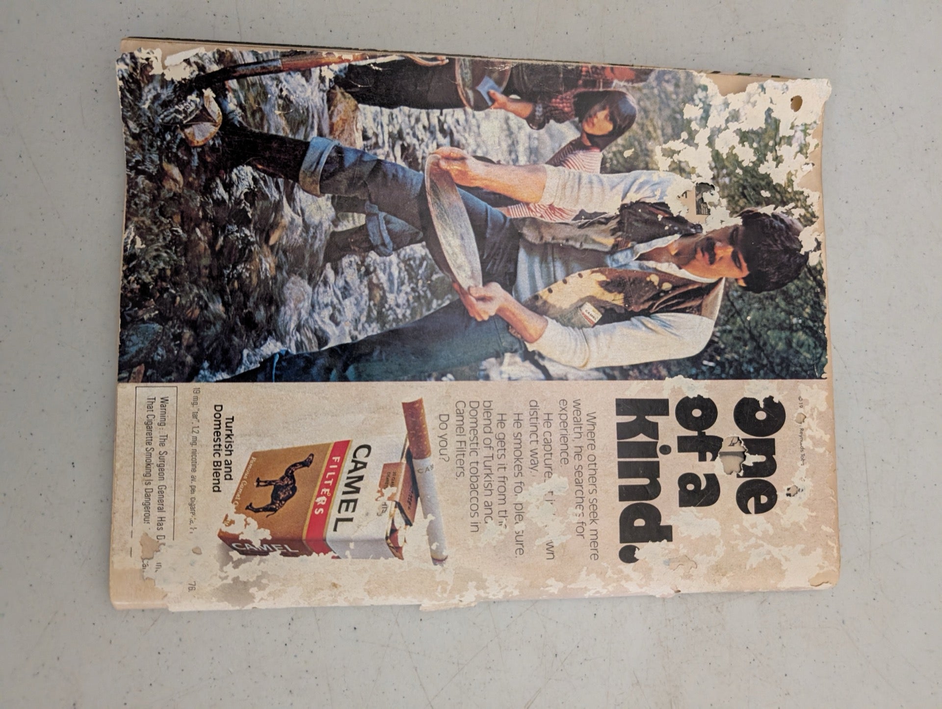 Back cover of vintage 1977 Playboy featuring a Camel cigarettes ad showing wear