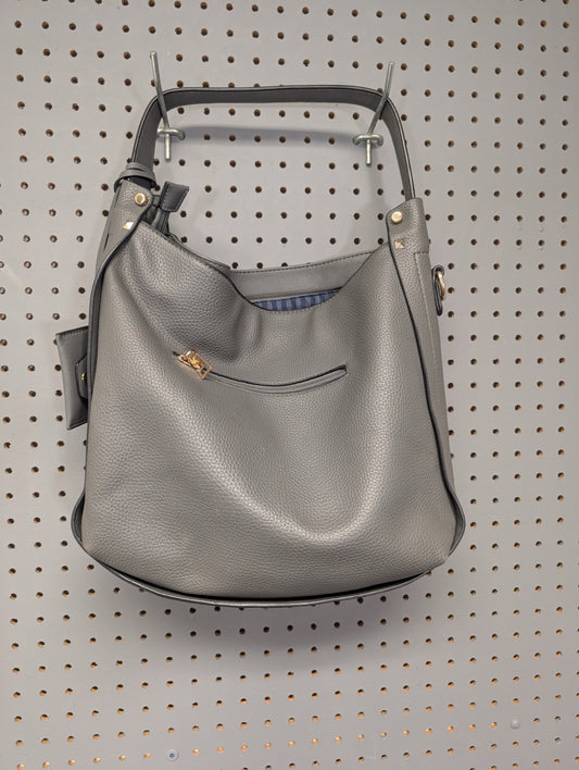 Back view of grey faux leather hobo bag on pegboard