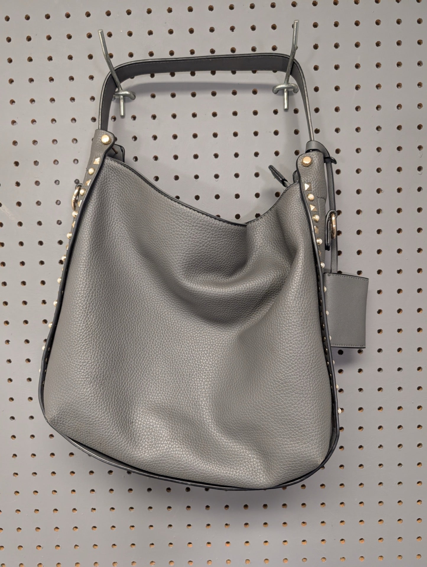 Front view of grey faux leather hobo bag with gold studs