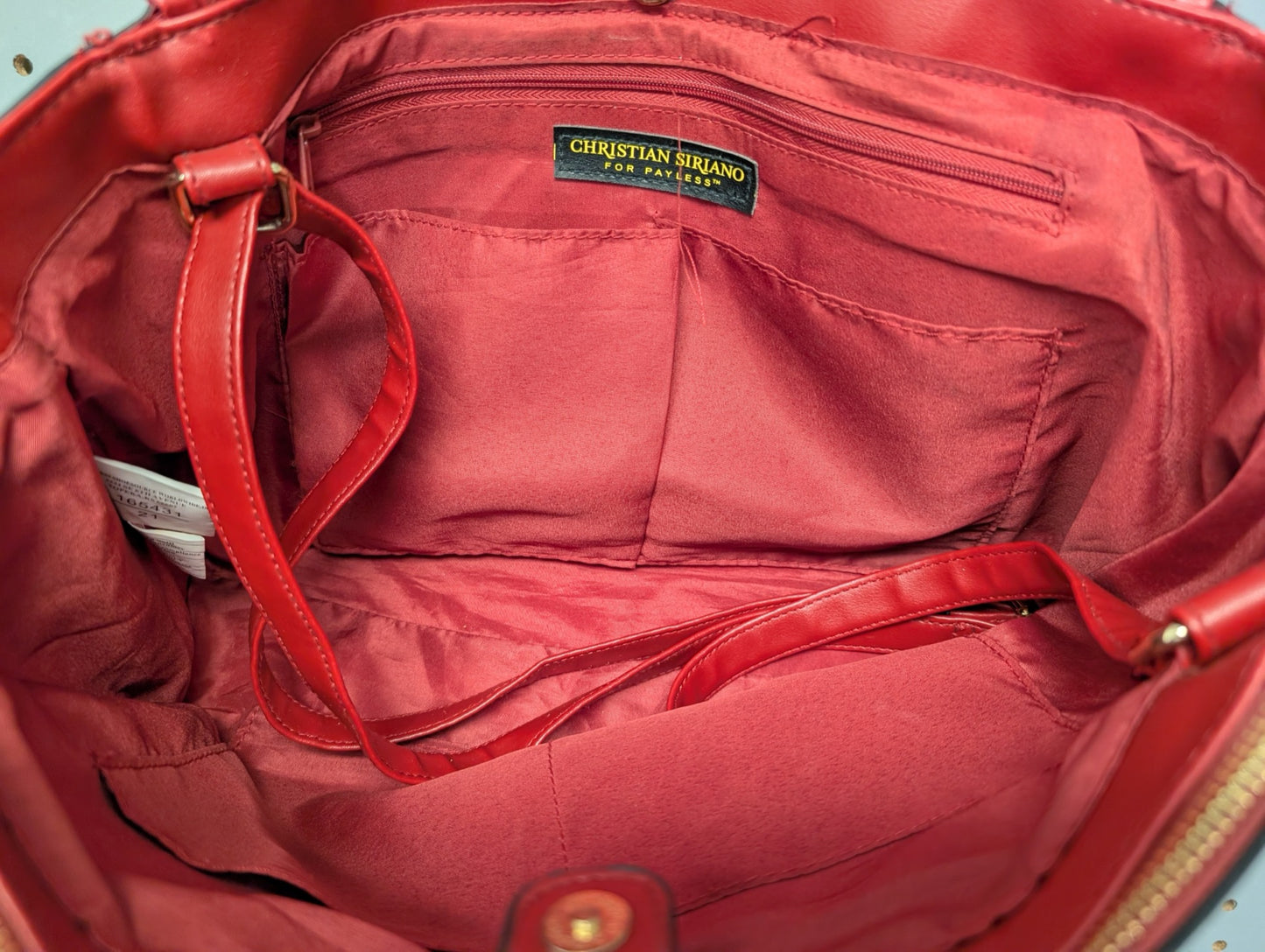 Interior view of red bag showing Christian Siriano tag