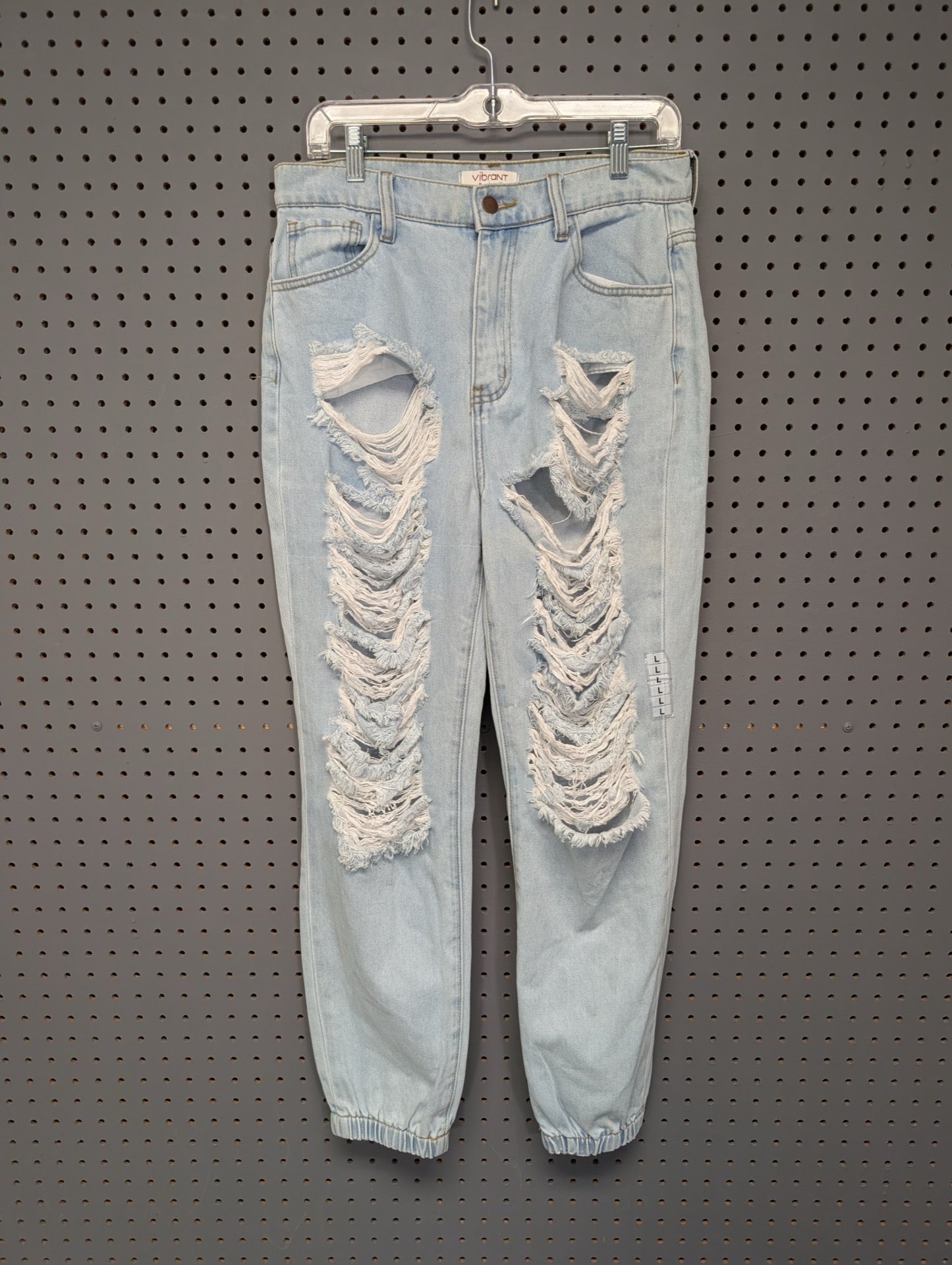 Front of Vibrant MIU heavily distressed denim joggers