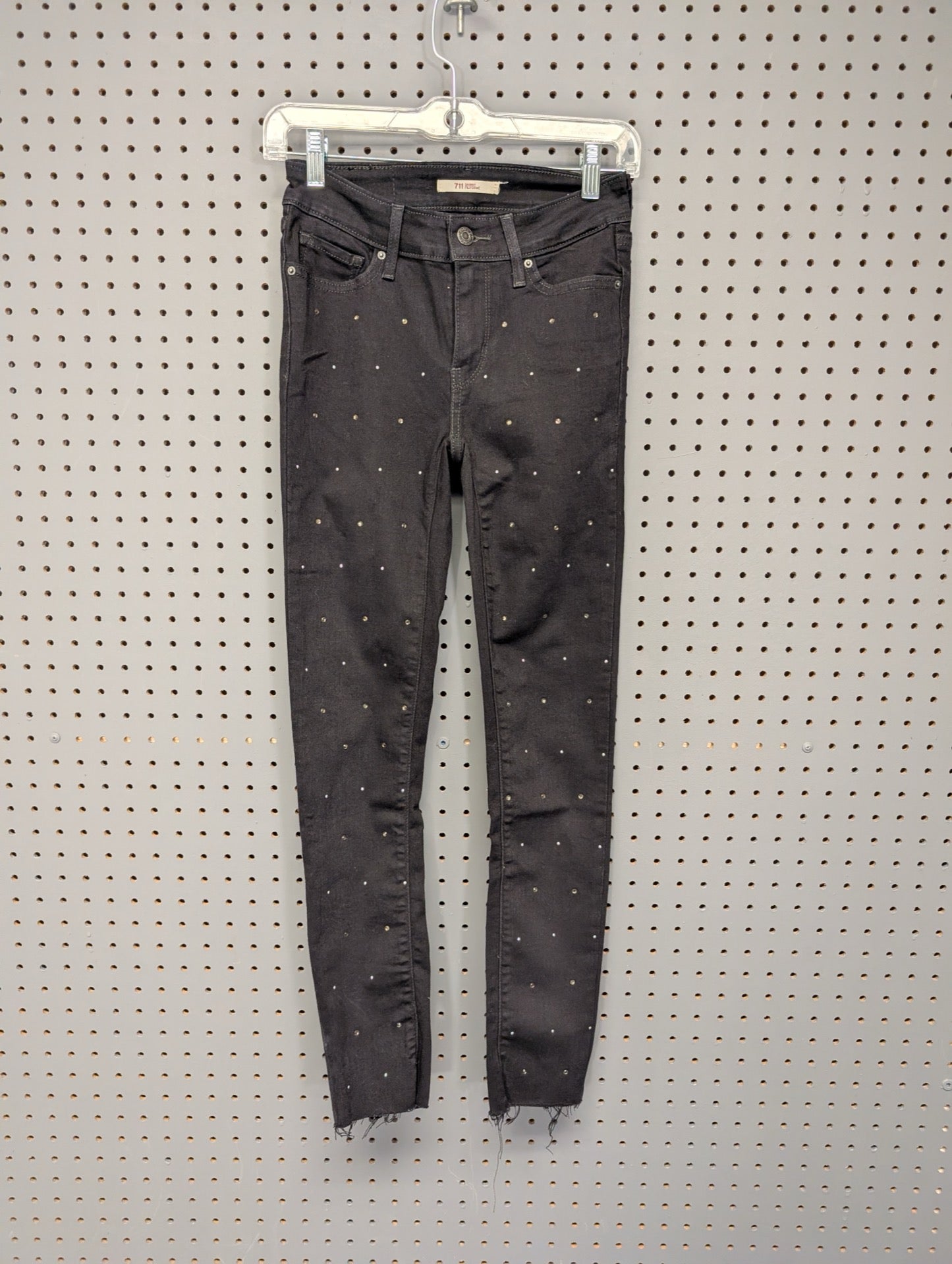 Front of Levis 711 embellished black jeans